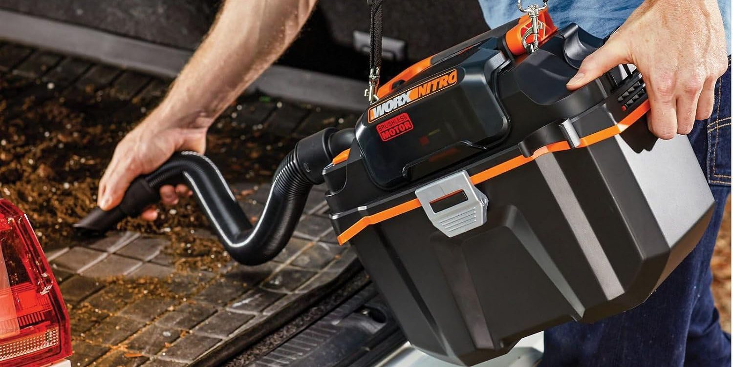 A person holding a black and orange tool