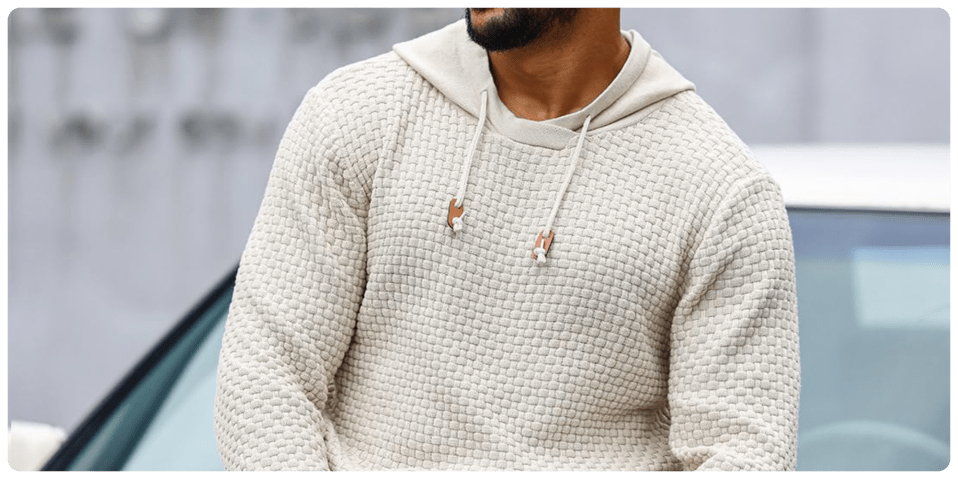 A man wearing a white sweater