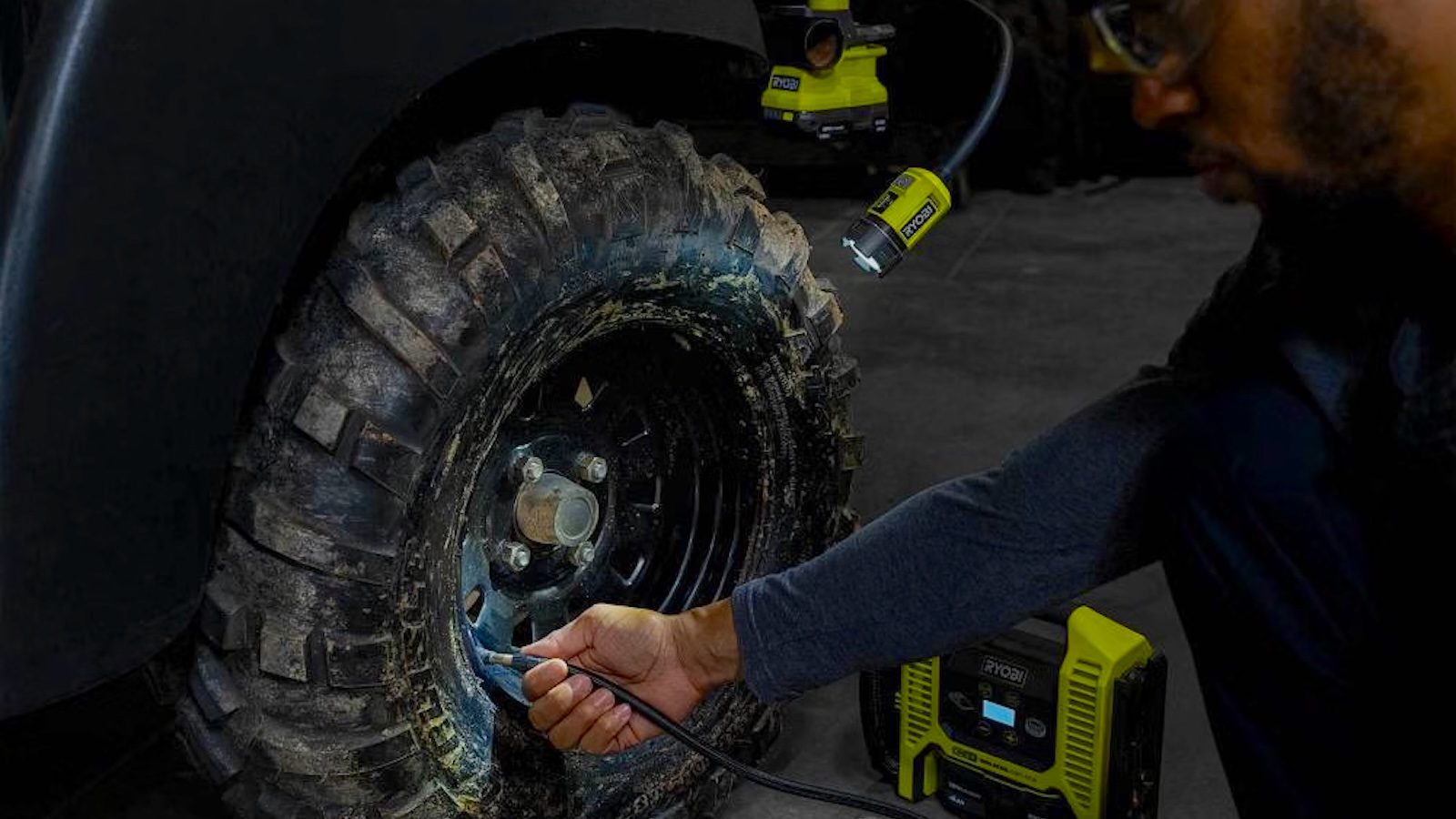 A person using a tool to fix a tire
