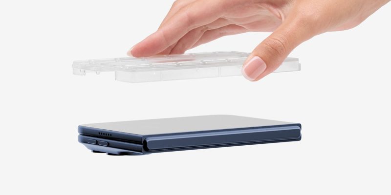 A hand holding a plastic container