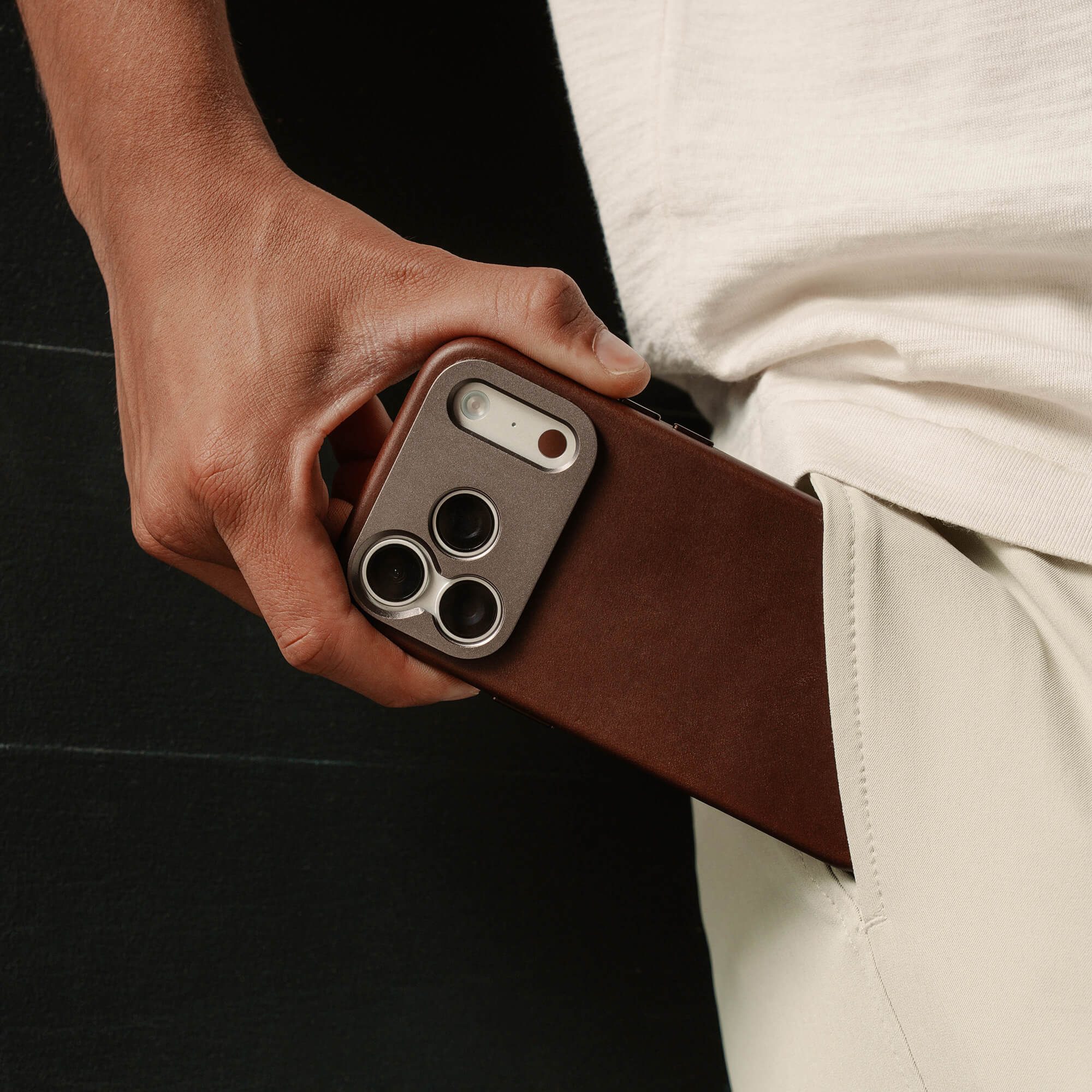 A person holding a phone in their pocket