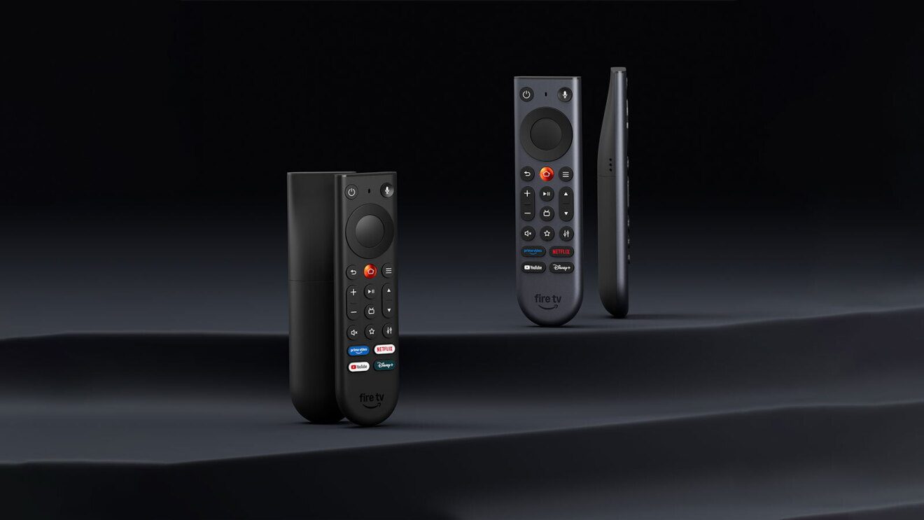 A group of remote controls on a black surface