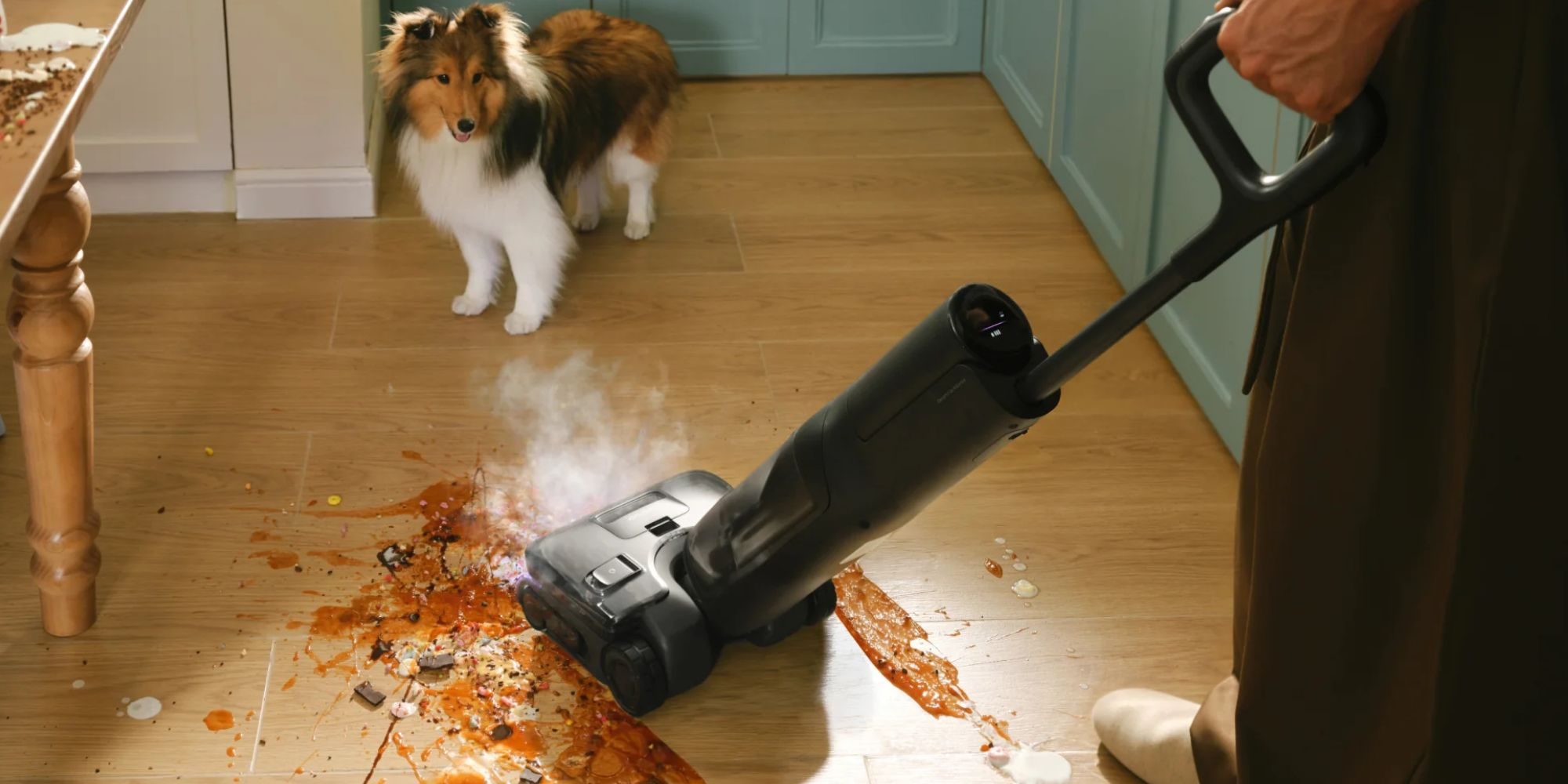 A dog standing next to a vacuum cleaner