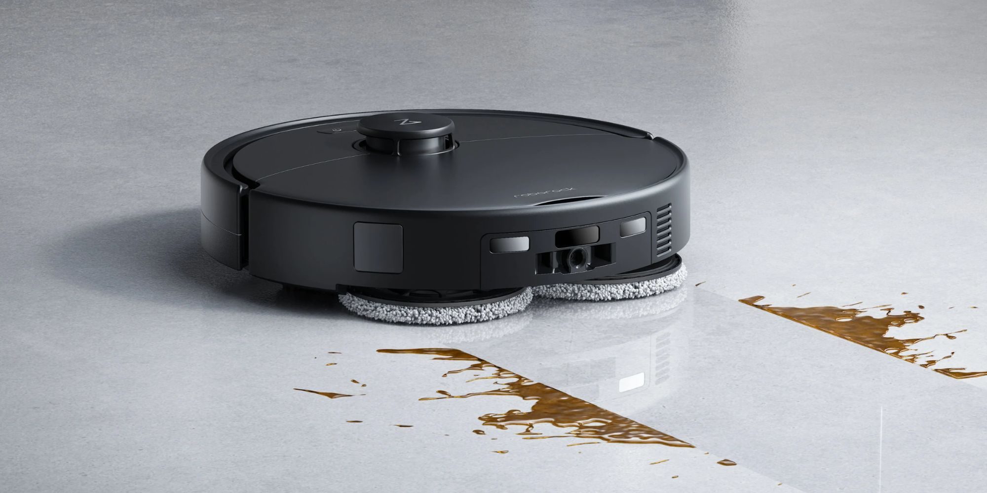 A black robot vacuum cleaner on a white surface