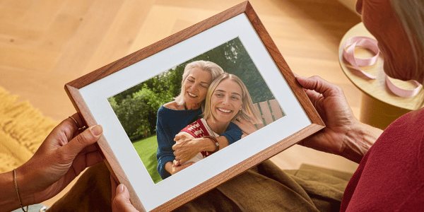 A person holding a picture of two women