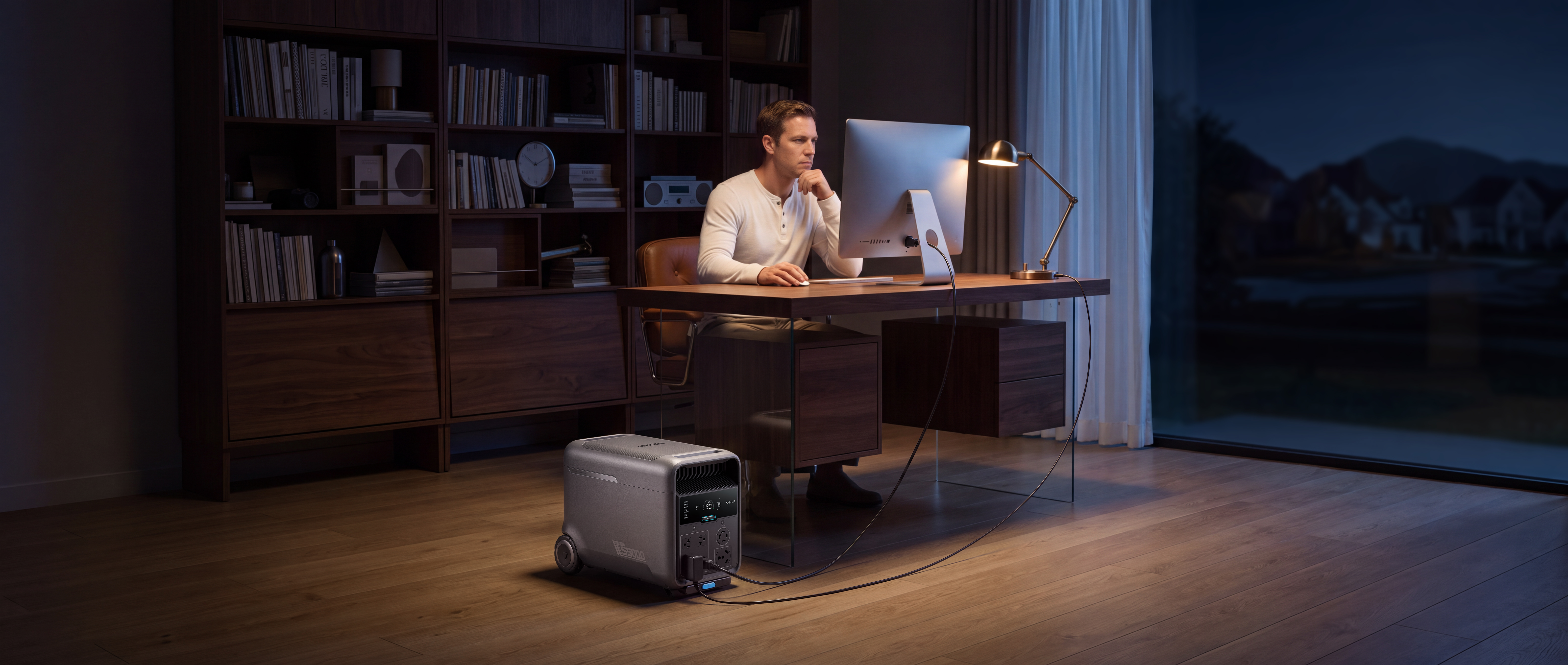 A man sitting at a desk with a computer