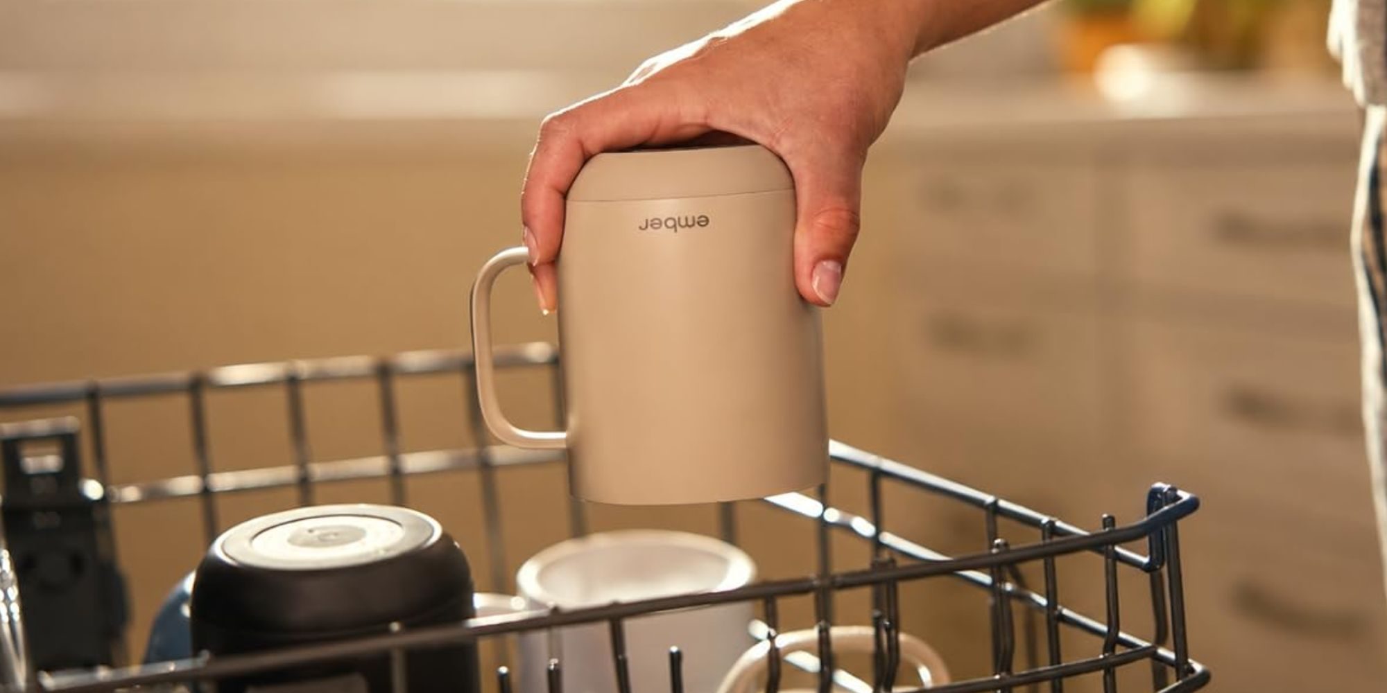 A hand holding a coffee mug