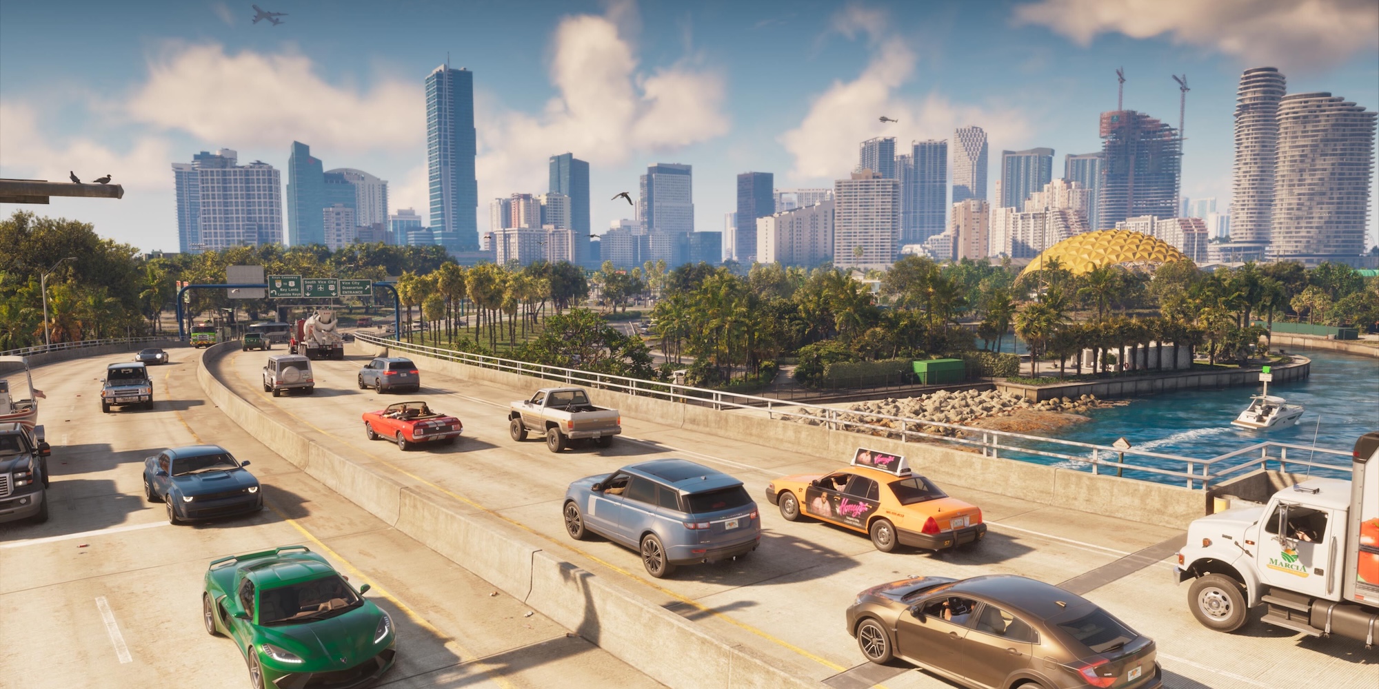 A group of cars on a highway with a city in the background