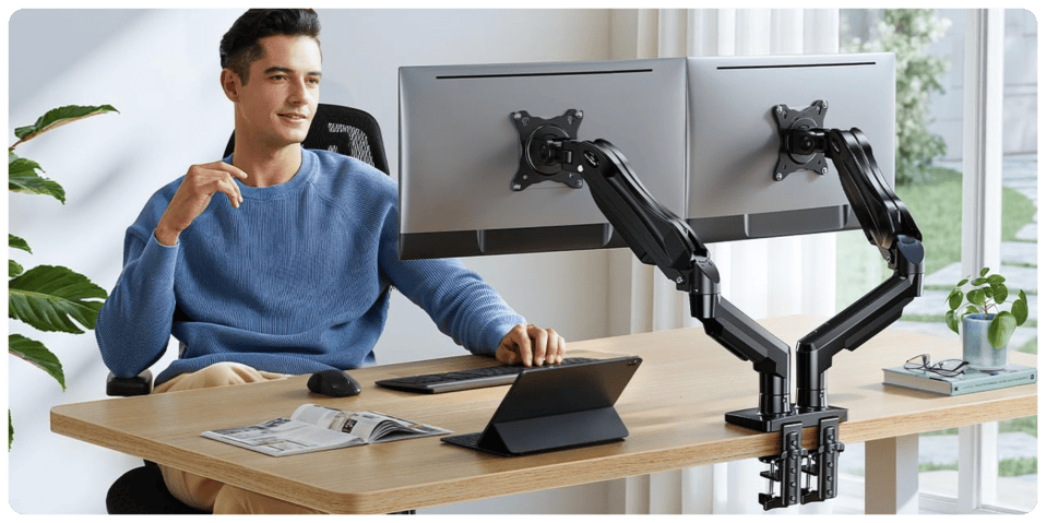 A man sitting at a desk with a computer arm
