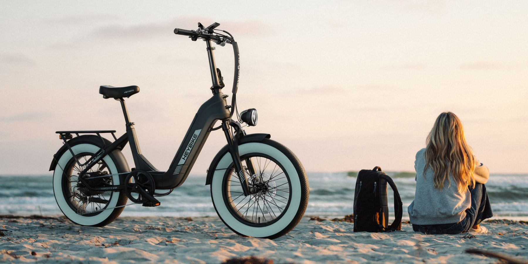 A black bike on a beach