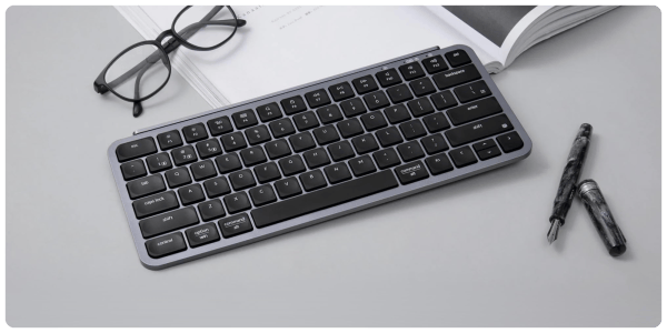 A keyboard and glasses on a table