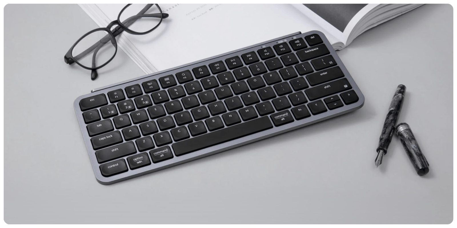 A keyboard and glasses on a table