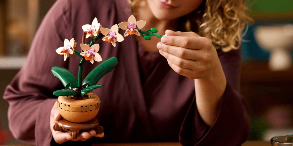 A woman holding a small flower