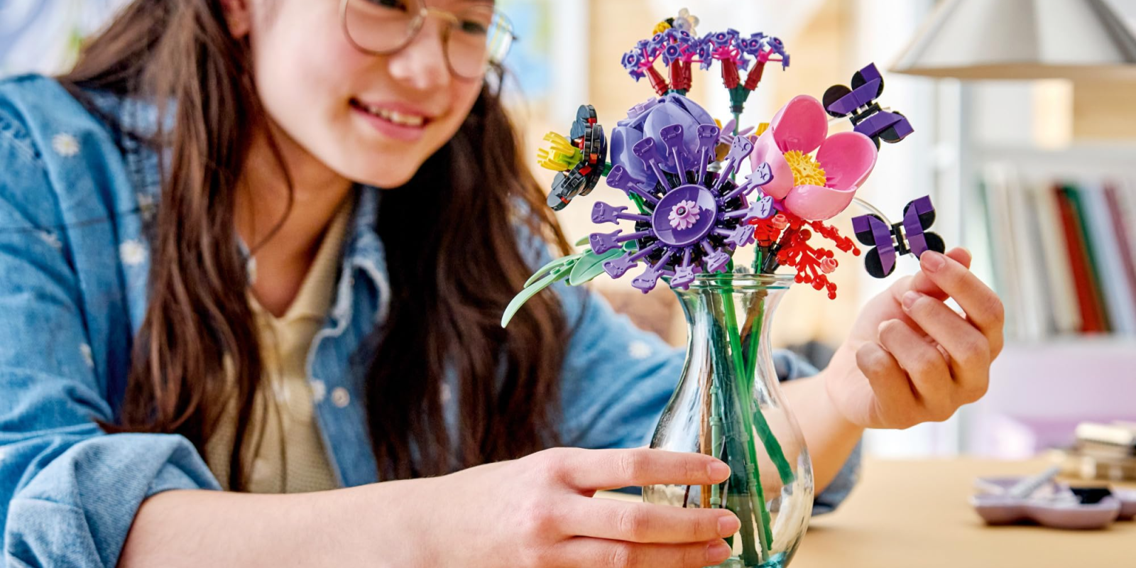 A girl holding a vase of flowers