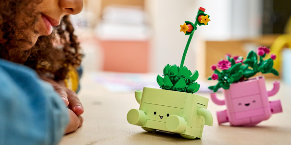 A child looking at a toy planter