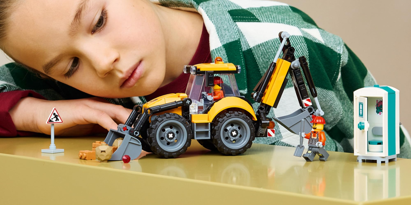 A child with a toy construction vehicle