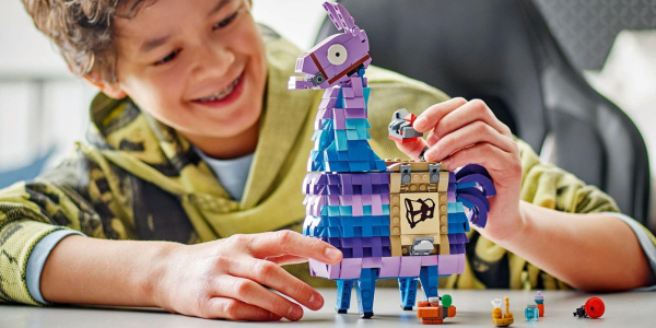 A child playing with a toy llama