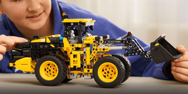 A toy tractor with a blue shirt