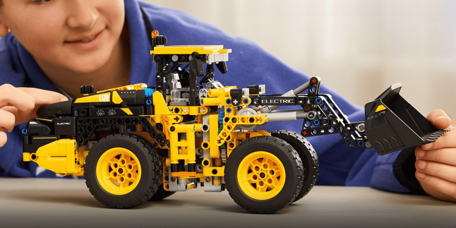 A toy tractor with a blue shirt