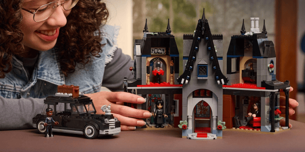 A person holding a toy house