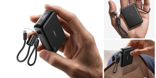 A hand holding a small black device