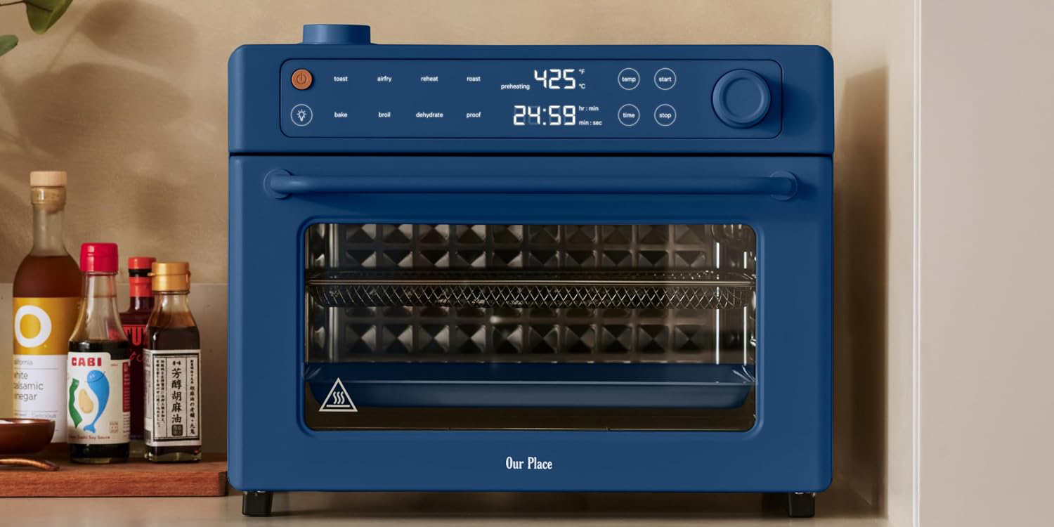 A blue oven with a screen and a number of times