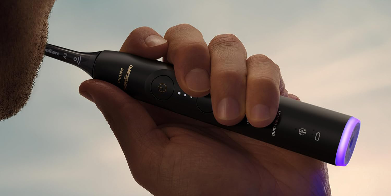 A hand holding a black device