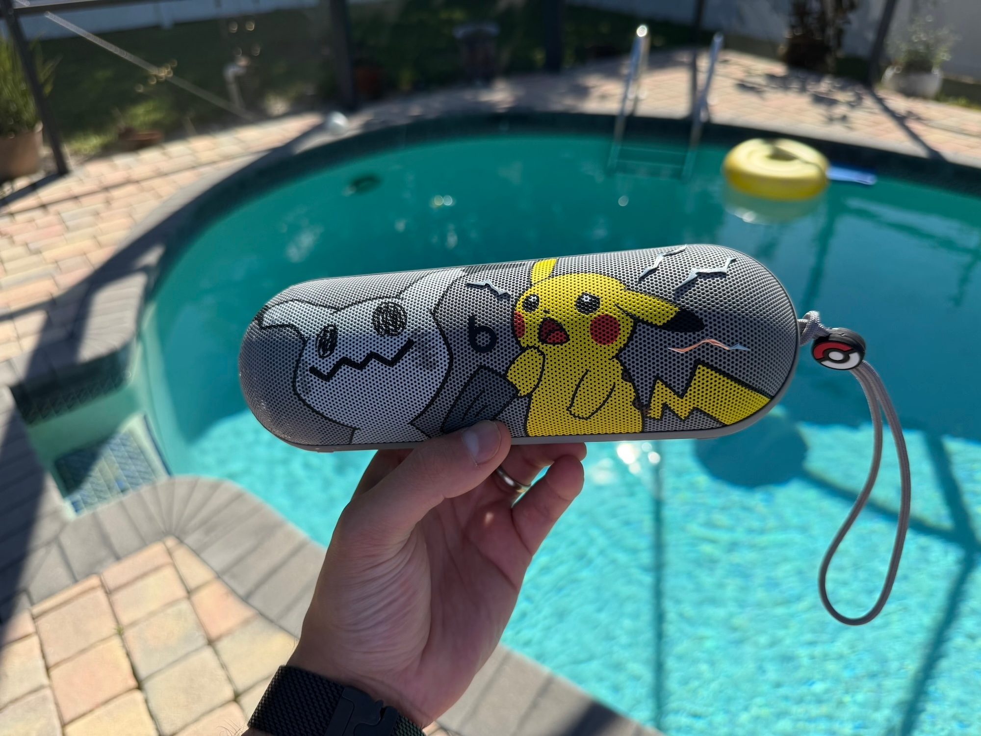 A hand holding a case with cartoon characters on it
