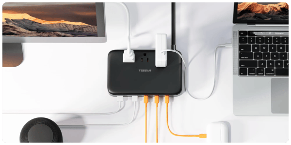 A black rectangular device with white cords connected to it