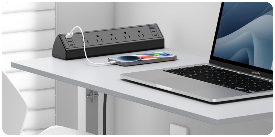 A cell phone charging on a laptop