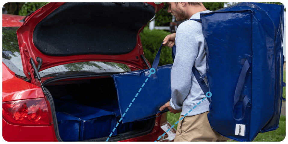 A man opening a trunk of a car