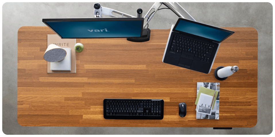 A desk with a computer and a laptop
