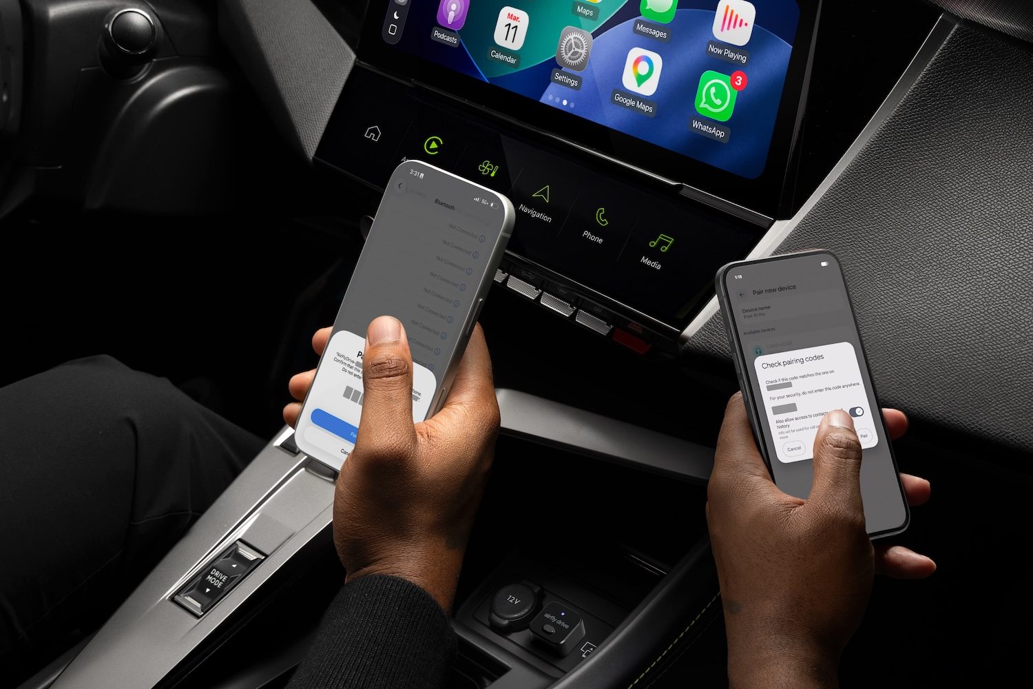 A person holding their phones in a car