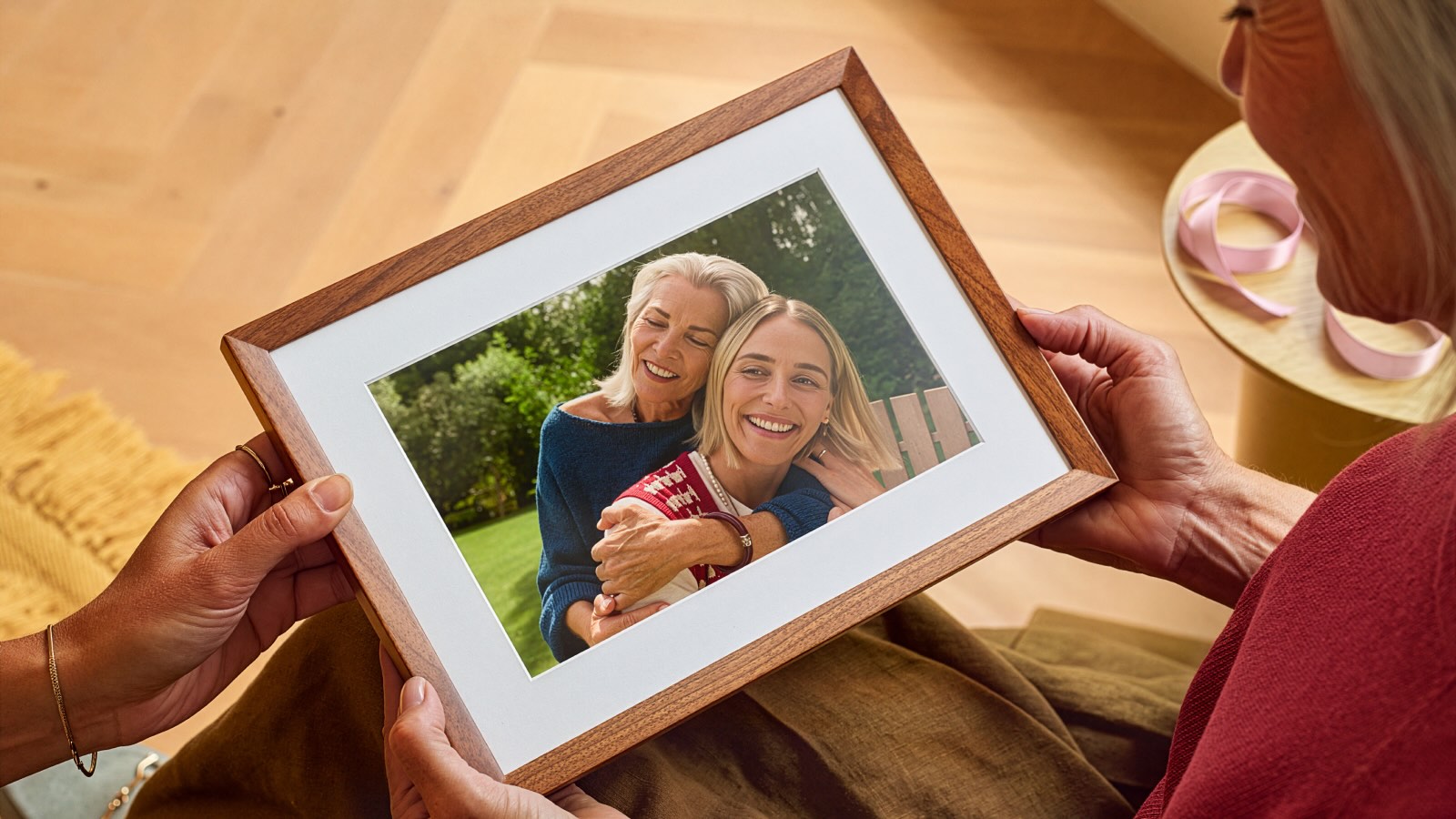 A person holding a picture of two women
