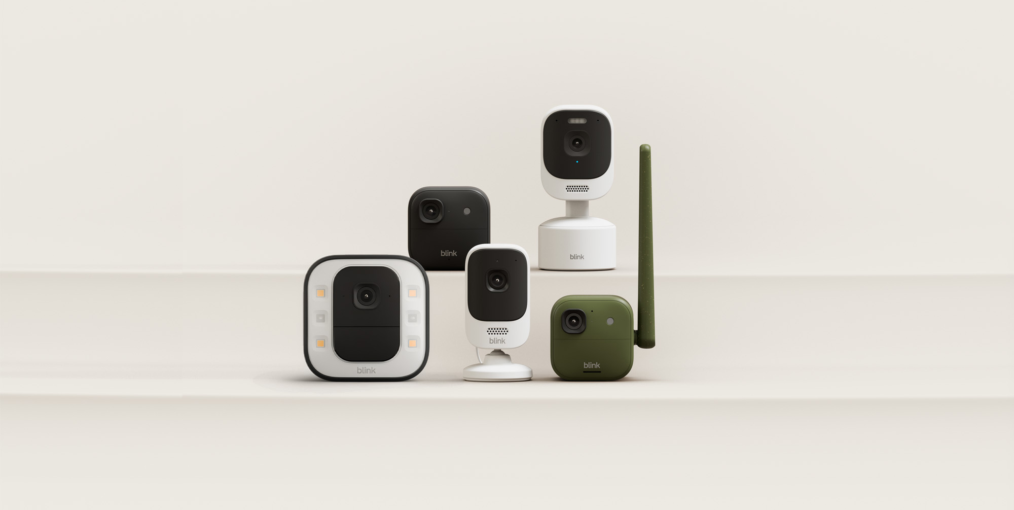 A group of cameras on a white surface