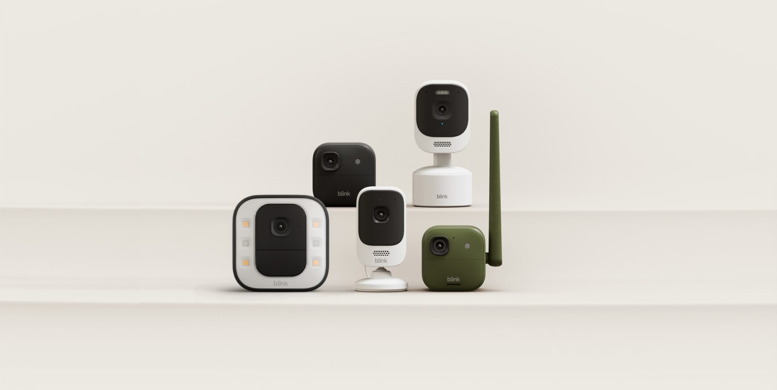 A group of cameras on a white surface